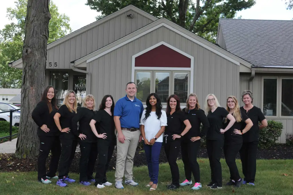 Doctors and staff of Maye Dental Associates outside of the office