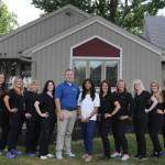Doctors and staff of Maye Dental Associates outside of the office
